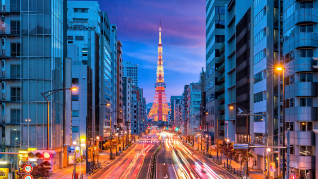 Tokyo Tower at dusk with car lights streaking through the city