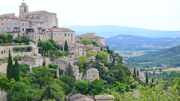 Gordes hilltop village in southern France overlooking lavender fields and valley