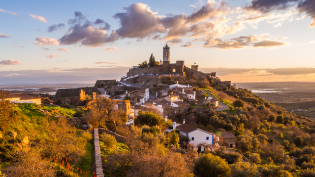 Monsaraz hilltop village in Portugal glowing under the sunset