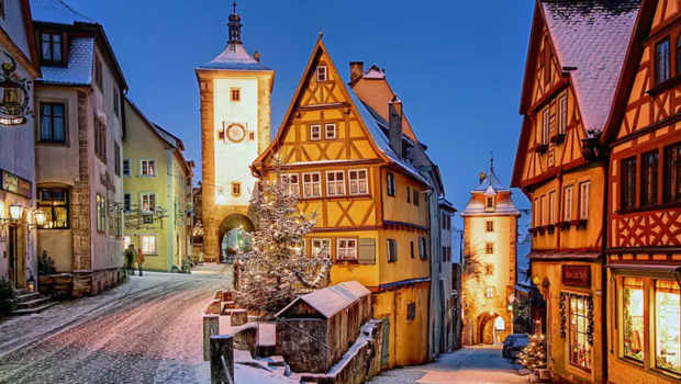 Rothenburg ob der Tauber, Germany in winter with snow-covered streets and warm lights