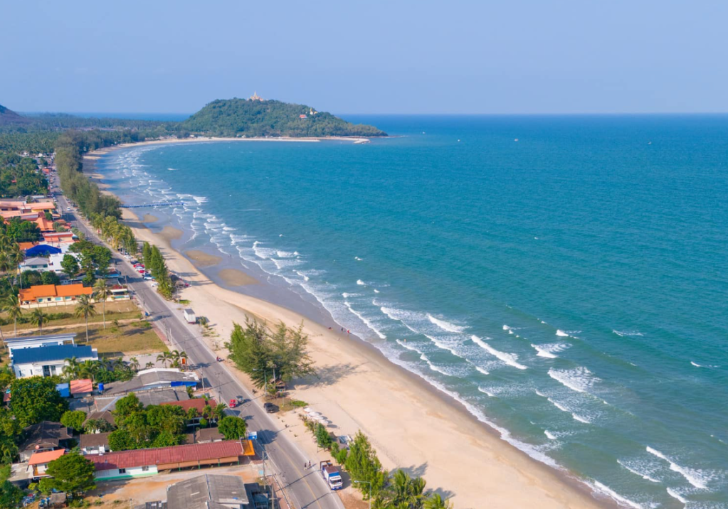Sunset beach with palm trees and footprints in the sand