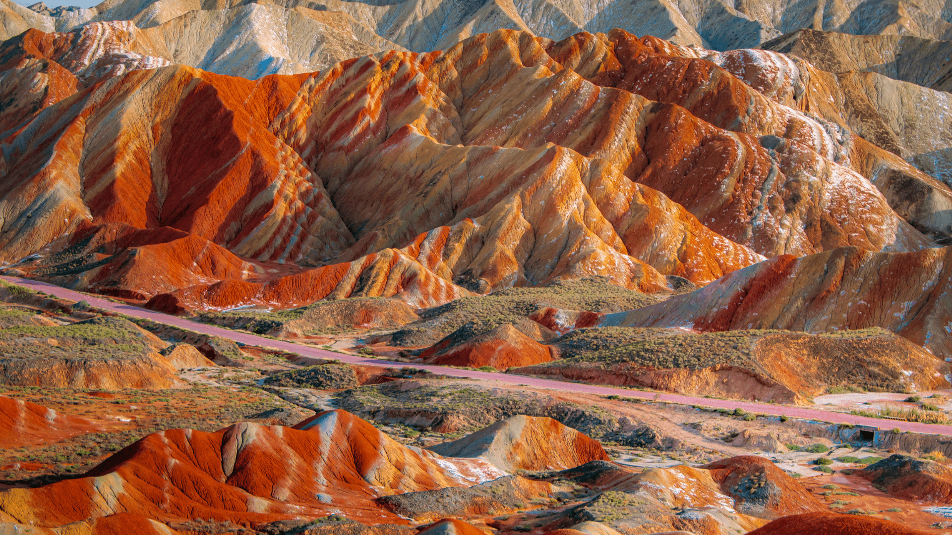 The vivid red, orange, and yellow stripes come from layers of sandstone and minerals laid down over millions of years. One of the most surreal geological parks on Earth.