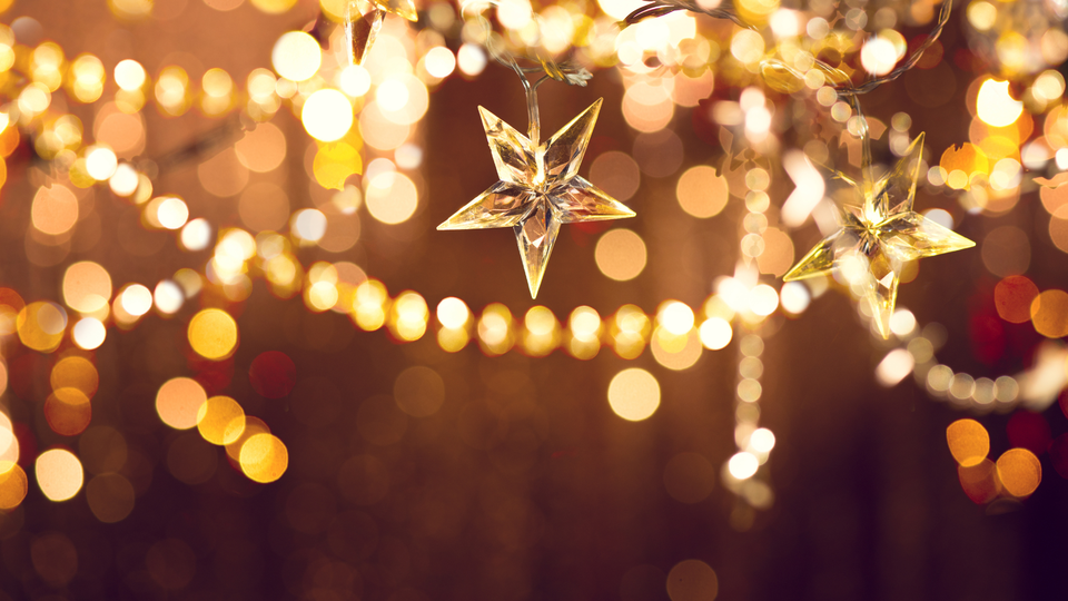 Warm golden star lights creating a soft, glowing atmosphere, representing inspiration, renewal, and a fresh start for the new year