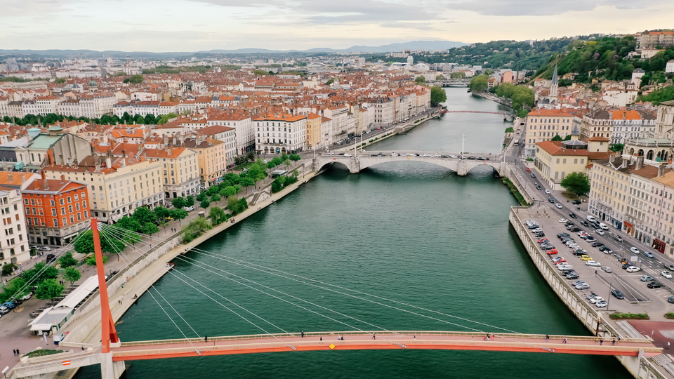Aerial view of Lyon old town with Saône river, bridges, and terracotta rooftops in France.
